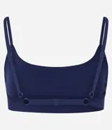 Top deportivo azul marino sin costuras, confeccionado en poliamida y elastano. Tiene breteles finos ajustables, espalda ajustable y detalle texturizado en el busto.