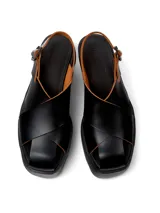 Sandalias negras de cuero vacuno con plataforma y tiras cruzadas.