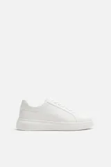 Zapatillas deportivas blancas de cuero sintético, con cordones y suela de goma con plataforma.