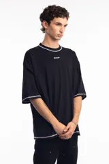 Remera negra de corte boxy con cuello redondo y costuras a la vista en color blanco.