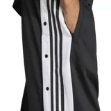 Pantalón deportivo Adidas Adibreak negro con rayas blancas laterales y botones a presión.