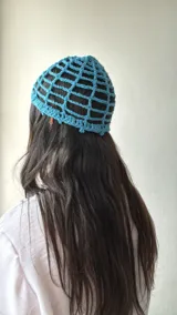 Gorro de crochet color celeste con diseño de red.