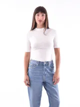 Polera blanca de manga corta con cuello alto.