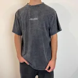Remera gris con efecto lavado, corte oversize y estampado en la espalda con esqueleto de pez, texto y logos de la marca Underwave Brand.