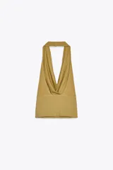 Top color ocre de algodón con cuello halter fluido, espalda descubierta y efecto lavado.