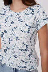 Remera de algodón con estampado floral en tonos azul y blanco, de corte ajustado y manga corta.