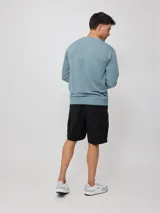 Sweater negro de corte regular con logo Rusty estampado en el pecho.