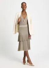 Pollera midi plisada color beige con lurex dorado, cintura elastizada y corte evasé.