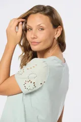 Remera color celeste con mangas cortas con detalle de broderie.