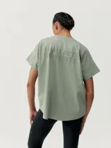 Camiseta blanca de manga corta estilo oversize con estampado en el pecho y la espalda.