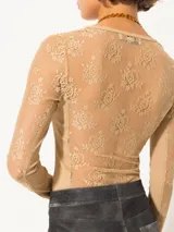 Remera de encaje negro translúcido, de corte ajustado, escote cuadrado y mangas largas.