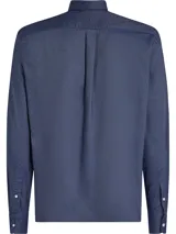 Camisa de manga larga Tommy Hilfiger de algodón Oxford color azul con cuello abotonado y logo bordado en el pecho.