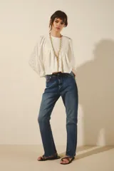 Pantalón de jean de calce recto tiro alto, confeccionado en denim azul con elastano, con lavado localizado con bigotes y torceduras.