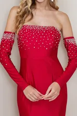 Vestido largo de fiesta negro, strapless, con mangas largas separadas y apliques de strass en el busto y en los puños.