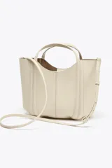 Bolso mini city color marrón con asa de mano y asa bandolera extraíble. Incluye bolsa interior extraíble con cierre mediante cremallera.