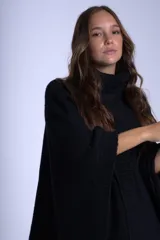 Poncho polerón negro tejido con cuello alto y mangas 3/4.