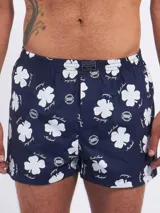 Bóxer de algodón blanco con estampado de flores pequeñas color celeste, con cintura elástica y logo de la marca en el centro.