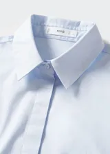 Camisa negra de popelina de algodón, de corte recto, con cuello camisero, manga larga con puños abotonados y cierre frontal con botones.