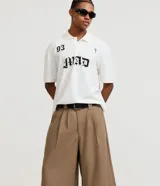 Bermuda masculina color beige, corte amplio, de viscosa y poliéster. Presenta cintura con trabillas, cierre tradicional y bolsillos laterales.