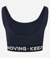 Top deportivo negro de microfibra con breteles anchos, copas desmontables, recorte cut-out en el busto y banda elástica con estampado de letras "Keep Moving".