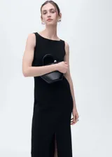 Vestido midi negro de punto fino, con cuello barco y abertura frontal en el bajo. Diseño recto y sin mangas.