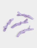 Set de cuatro piquitos para el pelo de acrílico color lila.