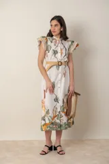 Vestido midi camisero de algodón color natural con estampado de flores, animales y ramas en tonos rojo, marrón, verde y azul. Tiene cuello mao, mangas cortas con volados, bolsillos laterales y cinturón de soga color beige.