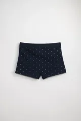 Boxer corto de algodón azul marino con estampado de anclas blancas. Tiene cintura elástica.
