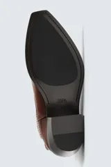 Bota de cuero color marrón, estilo cowboy, con caña corta, puntera en punta y tacón cubano.