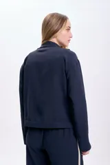 Campera azul marino con cierre frontal, capucha y dos líneas blancas verticales en las mangas.