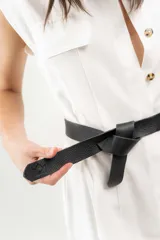 Cinturón de cuero negro, delgado y liso, con terminación en lazo.