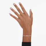 Pulsera plateada con hilera de cristales blancos y un cristal amarillo champagne central. Ajustable con cierre deslizante.