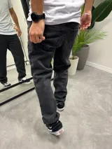 Pantalón de jean negro con efecto gastado, corte amplio y tiro medio.