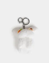 Llavero de peluche blanco con forma de conejo, con accesorios en las orejas y mosquetón metálico para colgar.
