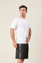 Bermuda deportiva de nylon color verde militar, de corte suelto, con cintura elástica, cordón de ajuste, detalles de líneas en los costados y bolsillos con cierre.