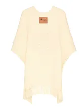 Ruana de lana merino color crema, tejida a mano con punto grueso y terminación con flecos.