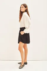 Short negro de viscosa con estampado jacquard, tiro alto y cinturón con hebilla metálica.