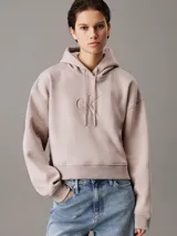 Buzo holgado con capucha Calvin Klein color lila, con logo CK bordado en relieve en el frente.