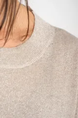 Sweater color cobre brillante, de tejido de punto con lurex, corte oversize, cuello redondo y mangas 3/4 con volados.