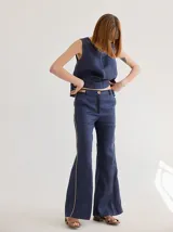 Pantalón de lino azul con corte palazzo y vivos a contratono color beige en los laterales.