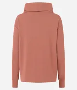 Polera hecha en tela canalé con tacto peluche, color ladrillo, con cuello alto, mangas largas y lazo en el bajo.
