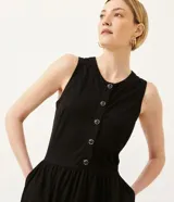 Vestido midi negro de punto orly, con abotonadura delantera y escote redondo.
