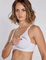 Soutien maternal de microfibra color blanco, sin costuras, sin aro ni copa, con breteles regulables y broches desmontables para amamantar.