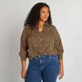 Blusa de manga larga con estampado animal print, cuello camisero y cierre frontal con botones.