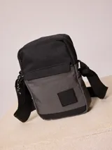 Bandolera negra y gris con correa ajustable y logo de la marca en el frente.