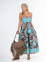 Vestido largo azul marino con estampado floral en tonos amarillo y blanco, de algodón italiano, con escote cuadrado, corte imperio y tirantes finos.