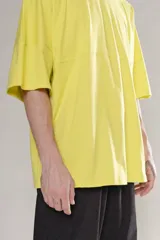 Remera amarilla de manga corta con calce oversize y cuello redondo.