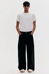 Remera blanca de algodón liviano con cuello redondo ribeteado y bajo recto. Corte ajustado que realza el contorno del cuerpo creando una silueta entallada.