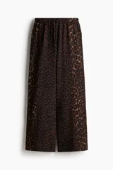 Pantalón de punto de corte holgado con piernas amplias, tiro alto, cintura elástica y cordón para ajustar.