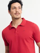 Chomba celeste con estampado de lunares blancos, cuello clásico y mangas cortas.